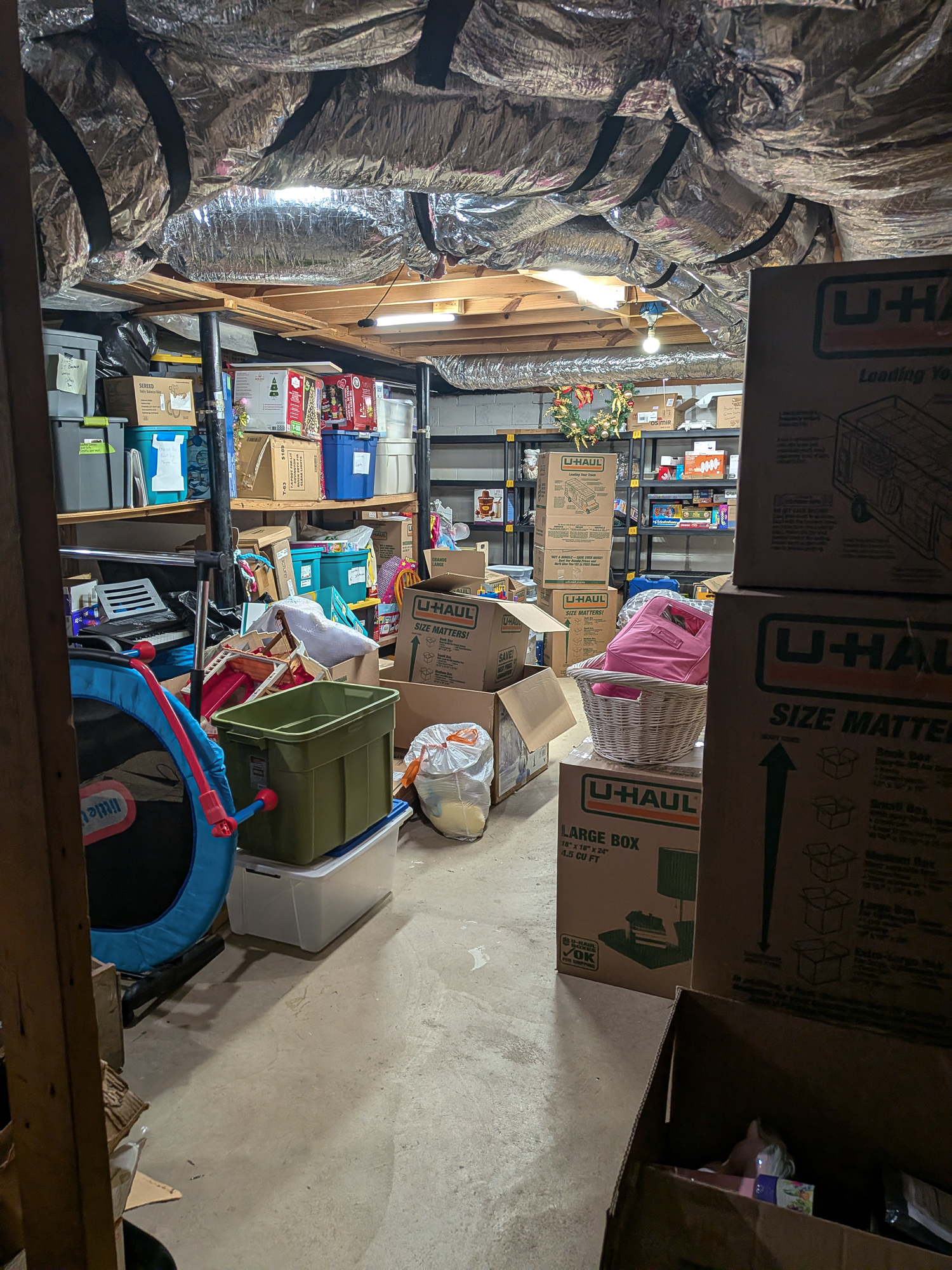Cluttered basement storage in Decatur, GA — before home organizing
